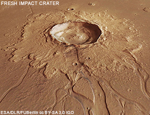 View of an impact crater surounded by material ejected by the impact